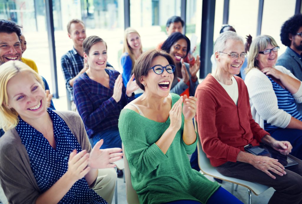 Cheerful audience in a meeting

